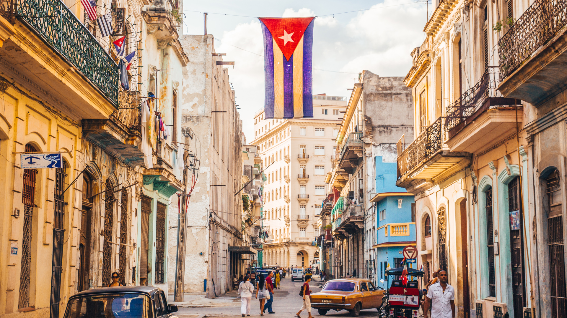Havana, Cuba - December 22, 2015: A Cuban flag with holes waves over a street in Central Havana.